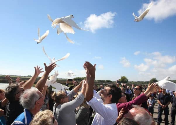 11 doves were released into the air as hundreds gathered to mark the first anniversary of the tragedy
