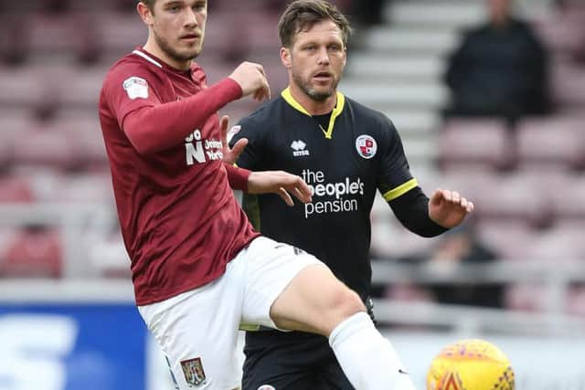 Timi Elsnik of Northampton Town controls the ball watched by Dannie Bulman of Crawley Town during the Sky Bet League Two match (Photo by Pete Norton/Getty Images)