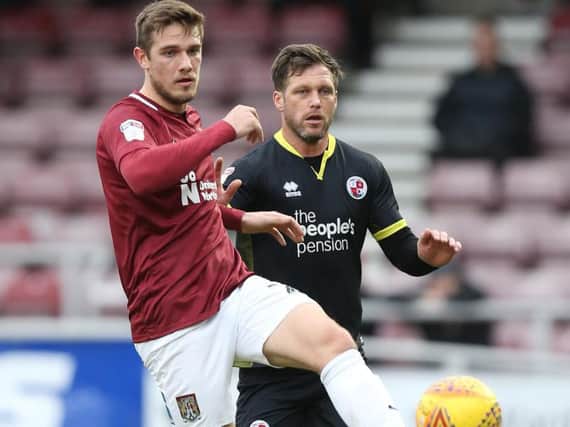 Timi Elsnik of Northampton Town controls the ball watched by Dannie Bulman of Crawley Town during the Sky Bet League Two match (Photo by Pete Norton/Getty Images)