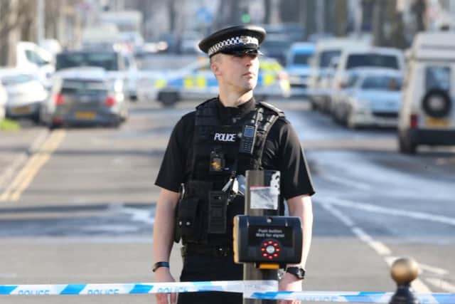 A police officer at the scene in Brighton today (February 17)