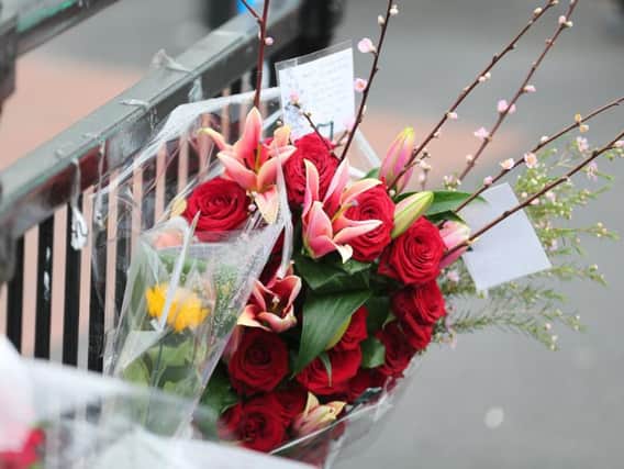 Flowers were tied to railings at Elm Grove, near the scene of the fatal stabbing