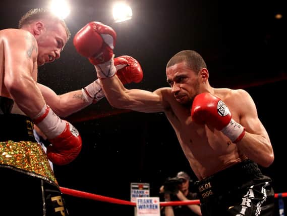 Curtis Woodhouse lands a punch against Frankie Gavin in 2011. (Photo by Scott Heavey/Getty Images)