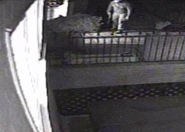 Operation Prometheus. CCTV footage of the burglar getting ready to enter a house with a sawn-off-shotgun. Supplied by Surrey Police. PPP-180130-120306001
