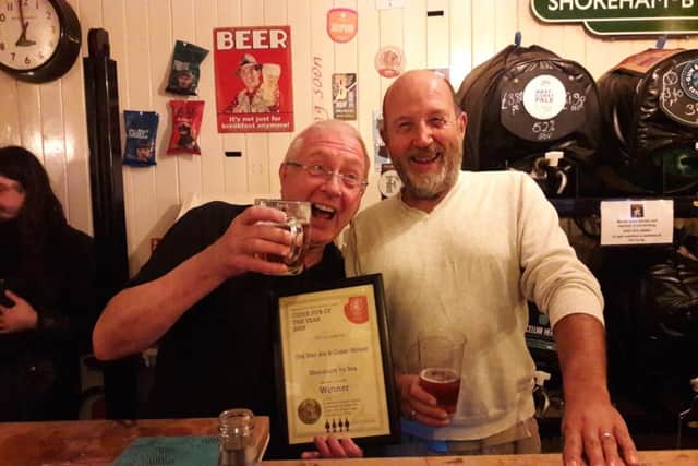 Steve Pardoe, branch co-ordinator for Brighton and South Downs CAMRA, presents the award to Old Star Ale and Cider House landlord Richard Hasler, left