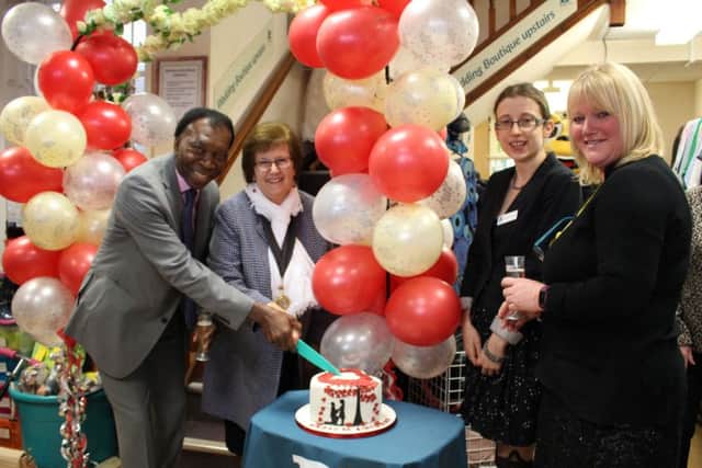 Cutting the cake at the Worthing St Barnabas House hospice shop Valentine's party