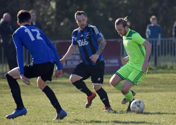 Allan McMinigal keeps a close eye on the AFC Ringmer player in possession. Pictures by Justin Lycett