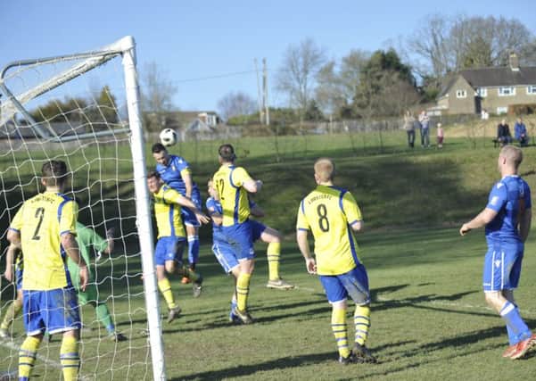 Battle Baptists captain Tom Saunders wins a header at a corner during the victory over St Teresa's Norris Green. Pictures by Simon Newstead
