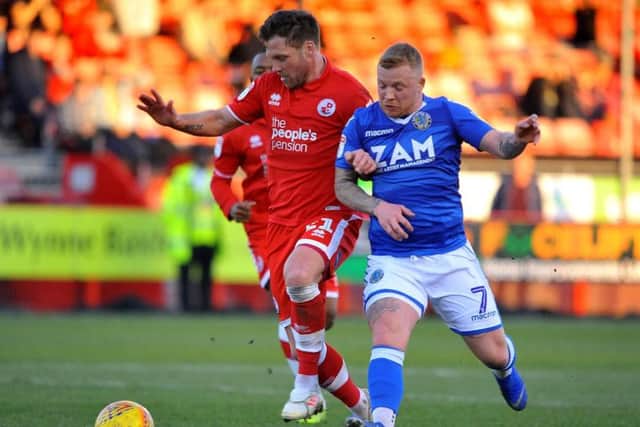 Crawley Town captain Dannie Bulman battles for the ball with Macclesfield Town's Elliot Durrell. 
Picture by Steve Robards