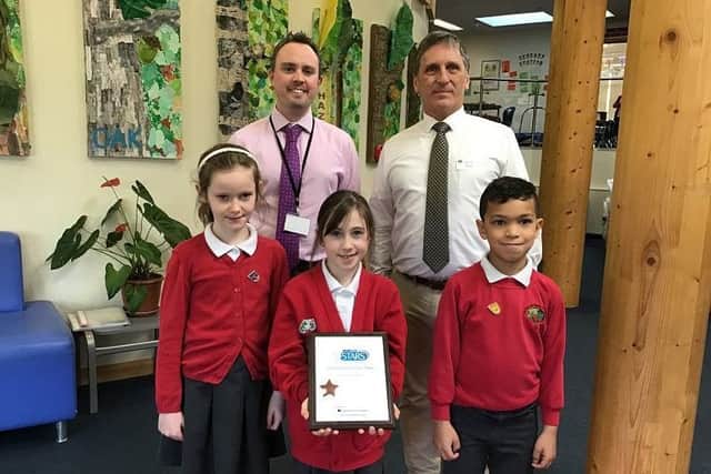 Councillor Stephen Hillier presenting the award to headteacher Mark Sears and some of the children at Northlands Wood Primary Academy in Haywards Heath