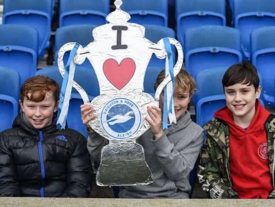 Young Brighton fans pictured with a homemade FA Cup at the fifth round win against Derby. Picture by PW Sporting Photography