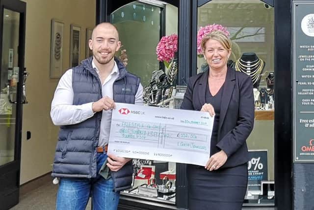Sophie Cullen, owner of L. Guess Jewellers, presents the cheque to Freestyle 4 Smiles founder Nathan Abbott