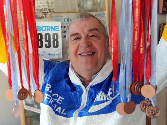 Graham Jessop with the old half marathon medals / Picture by Kate Shemilt