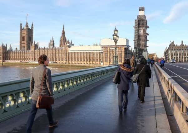 People walk across Westminster bridge next to the Houses of Parliament, London. PRESS ASSOCIATION Photo. Picture date: Wednesday November 14, 2018. Prime Minister Theresa May will put her Brexit plans to the Cabinet on Wednesday, 874 days after Britain voted to leave the European Union. See PA story POLITICS Brexit. Photo credit should read: Andrew Matthews/PA Wire PPP-181115-102749003