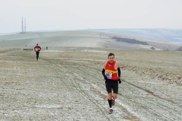 Lewis Sida pulls away from Mike Ellicock on the way to Firle Beacon in last year's marathon. Photograph: James McCauley