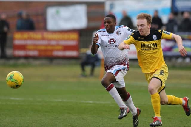 Hastings United wide player Lanre Azeez in a race for the ball against Haywards Heath Town. Picture courtesy Scott White
