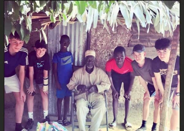 Boys from St Catherine's meet villagers in The Gambia SUS-190503-170847001