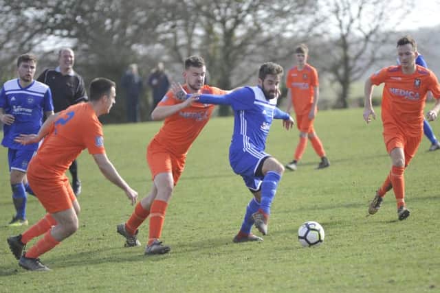 Action from the top-of-the-table clash between Sidley United and Battle Baptists