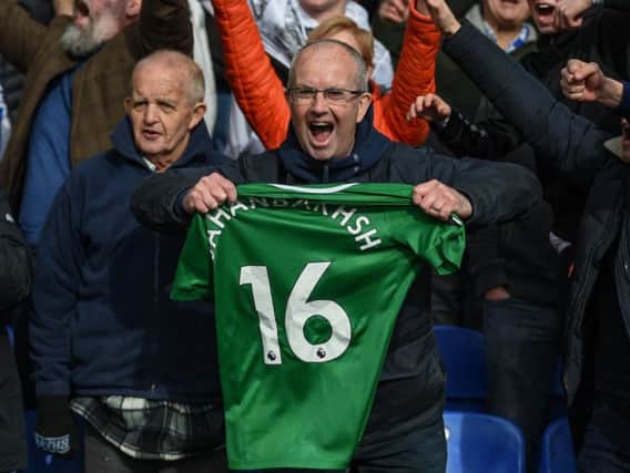 Albion fans celebrate the win with Alireza Jahanbakhsh's matchworn shirt. Picture by PW Sporting Photography