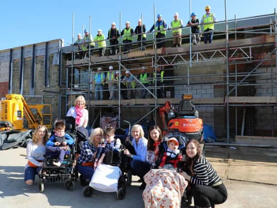 Staff and pupils celebrate the "topping out" of local charity, Chailey Heritage Foundation's DREAM Centre