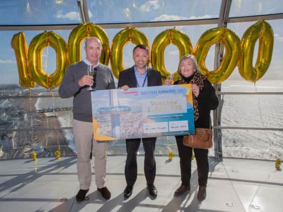Sue Waghorn, from Greenwich, celebrates being the one millionth visitor at the i360 with husband Philip (left) and i360 general manager Ian Hart (centre). Photograph: David Hugh/ Brighton Pictures