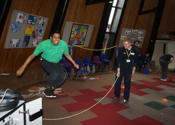 An LVS Hassocks student is coached at skipping by a Hurstpierpoint College sports leader