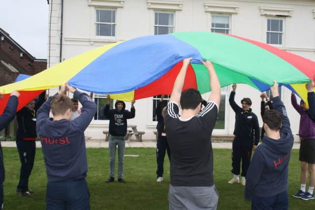 Students from LVS Hassocks and Hurstpierpoint College enjoy playing parachute games