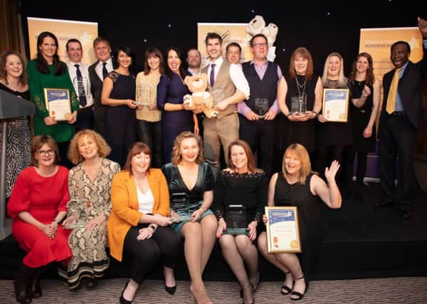Chestnut Tree House Business Awards 2019 winners on stage with hosts Allison Ferns and Ambrose Harcourt, Chestnut Tree House vice-president