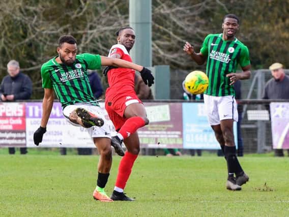 Cheick Toure clears the ball for Burgess Hill Town in their 3-0 home defeat against Leatherhead in the Bostik Premier on Saturday. All pictures by Chris Neal.