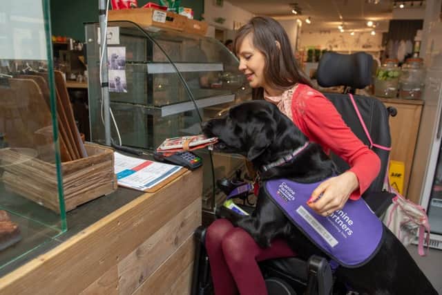 Assistance dog Ethan helps Sally Whitney with many tasks. Picture: Paul Davey / SWNS