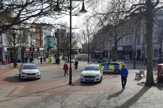 Police at the scene in Worthing town centre today (March 14)