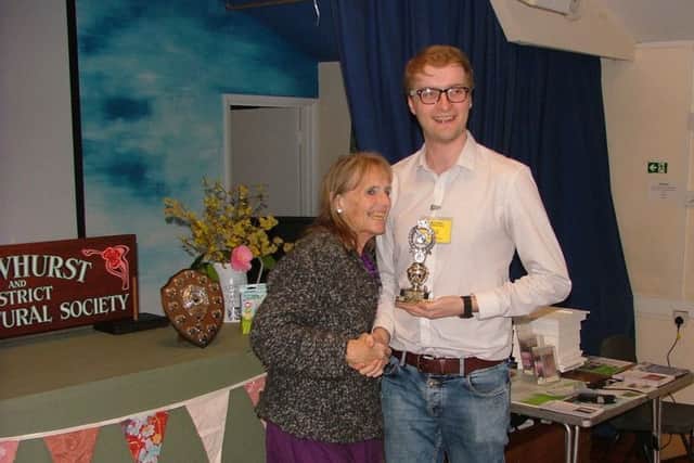 Crowhurst and District Hoticultural Society Chair Mary Boorman receives the Floral Art Cup from Oliver Boorman-Humphrey at the Spring Flower Show SUS-190320-112254001