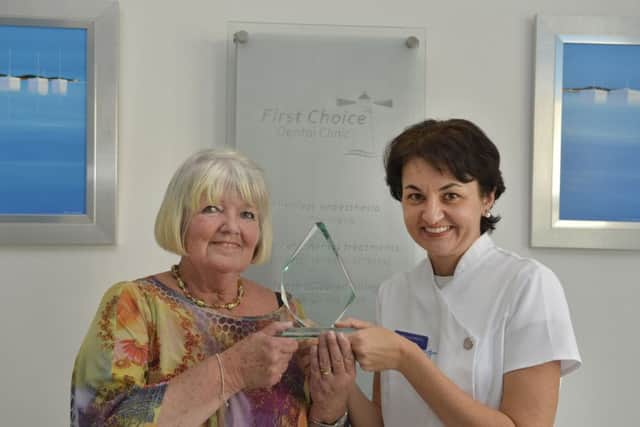 Gina Moulding receives her Women in Business Award from Dr Aniko Lazar at First Choice Dental Practice in Eastbourne (Photo by Jon Rigby) SUS-170928-111635008