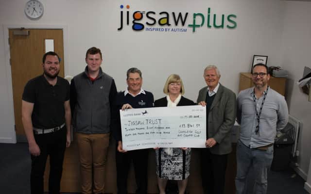 Presenting the cheque for nearly £14,000