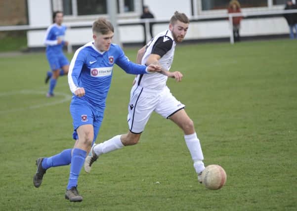 Nathan Lopez wins possession during Bexhill United's most recent league game, at home to Oakwood on Saturday March 9. Picture by Simon Newstead