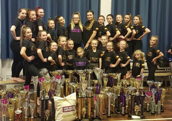 Justdance Academy celebrating with their trophies