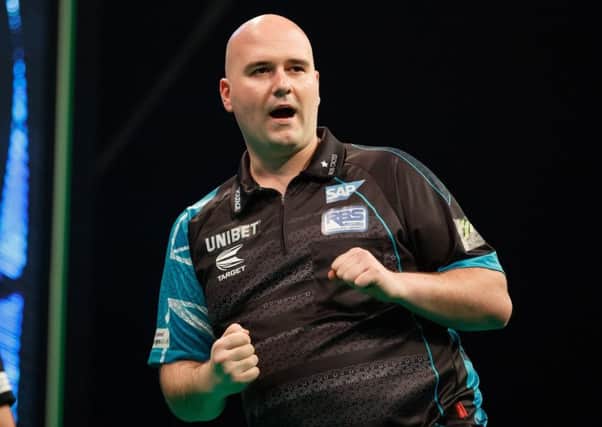Rob Cross is sitting proudly on top of the Unibet Premier League after night seven in Berlin. Picture courtesy Steve Welsh/PDC