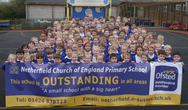 Pupils from Netherfield School hold up a banner celebrating the school's outstanding rating by Ofsted. SUS-190322-132834001