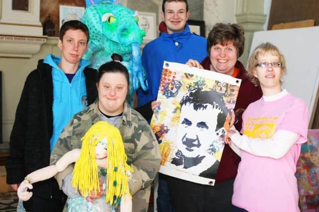 Members of Superstar Arts with artworks including a picture made as a tribute to Martin Dickinson. Photo by Derek Martin DM1932242a