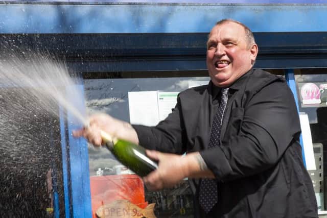 Paul Trollope from Horley celebrates his big win with a bottle of bubbly
