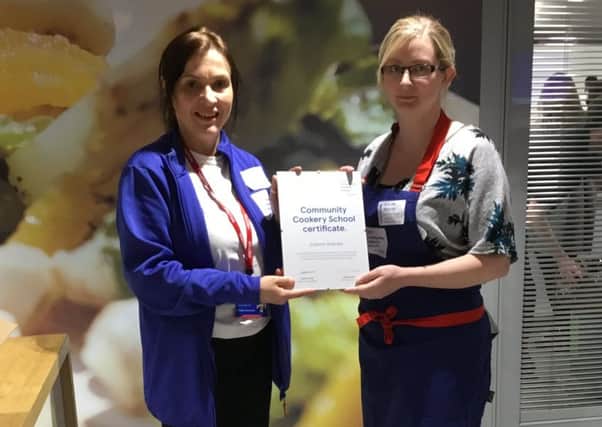 Joanne Shanley from Jack and Jill Preschool in Horsham with her Jamie Oliver certificate after participating in the Tesco Community Cookery School SUS-190415-141131001