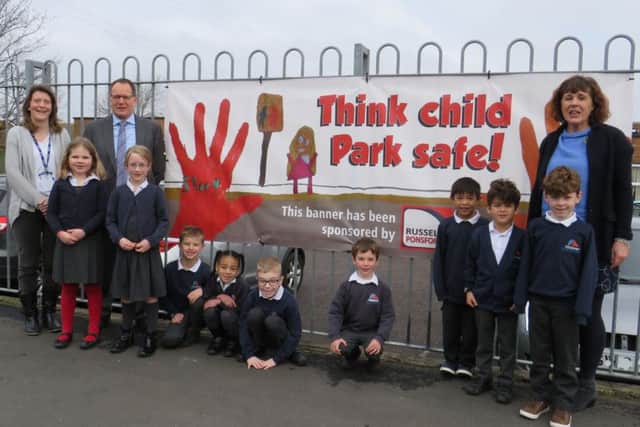 Pupils from Lyndhurst Infant School with the banner they designed to make sure people park safely
