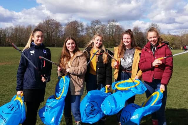 Millie Patel, Anna Owen, Olivia Heap, Maisie Ridpath and Ella Dallimore picking litter to raise money for their Ghana trip