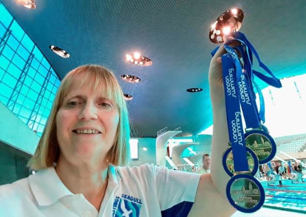 Hastings Seagull swimmer Laura Quye proudly displays her five medals