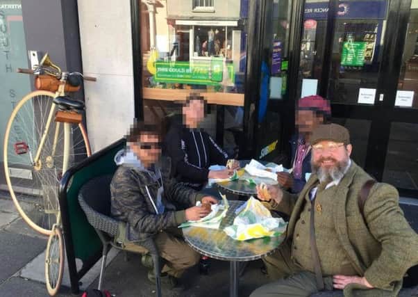 Steven Payne was bought lunch by the homeless people he has helped. In agreement with him we have modified the photo to protect the identities of those he is lunching with.
