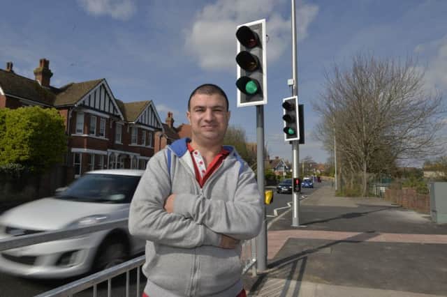 Matt Zalman at the traffic lights that he campaigned for outside St Thomas a Becket School in Eastbourne (Photo by Jon Rigby)