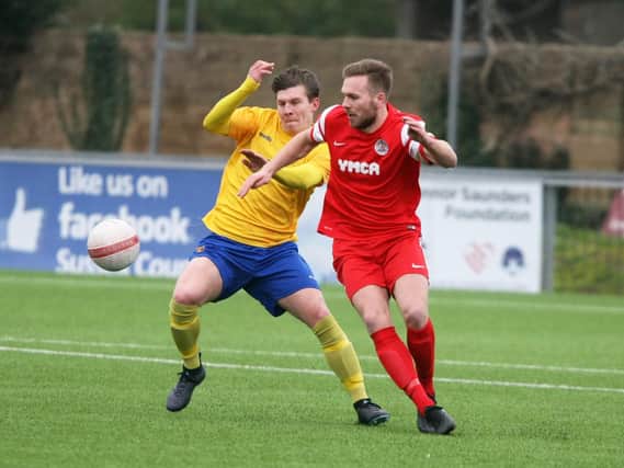 Alex Barbary (in red) put Horsham YMCA ahead in their 1-1 draw with Newhaven. Picture by Derek Martin.