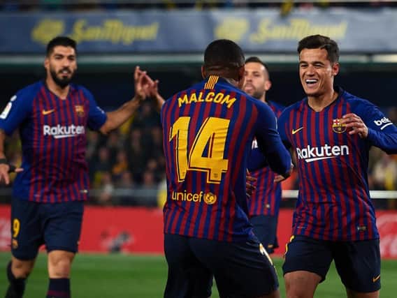 Philippe Coutinho celebrates after scoring his team's first goal with his teammate Malcom during the La Liga match against Villarreal CF(Photo by Manuel Queimadelos Alonso/Getty Images)