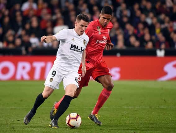 Valencia's French forward Kevin Gameiro vies with Real Madrid's French defender Raphael Varane during the Spanish league football match between Valencia CF and Real Madrid CF at the Mestalla stadium (Photo by JOSE JORDAN/AFP/Getty Images)