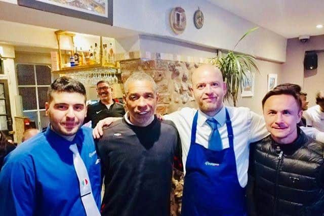 Restaurant manager Mario, Des Walker, waiter Francesco and Dennis Wise