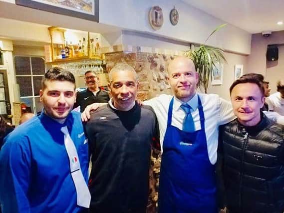 Restaurant manager Mario, Des Walker, waiter Francesco and Dennis Wise